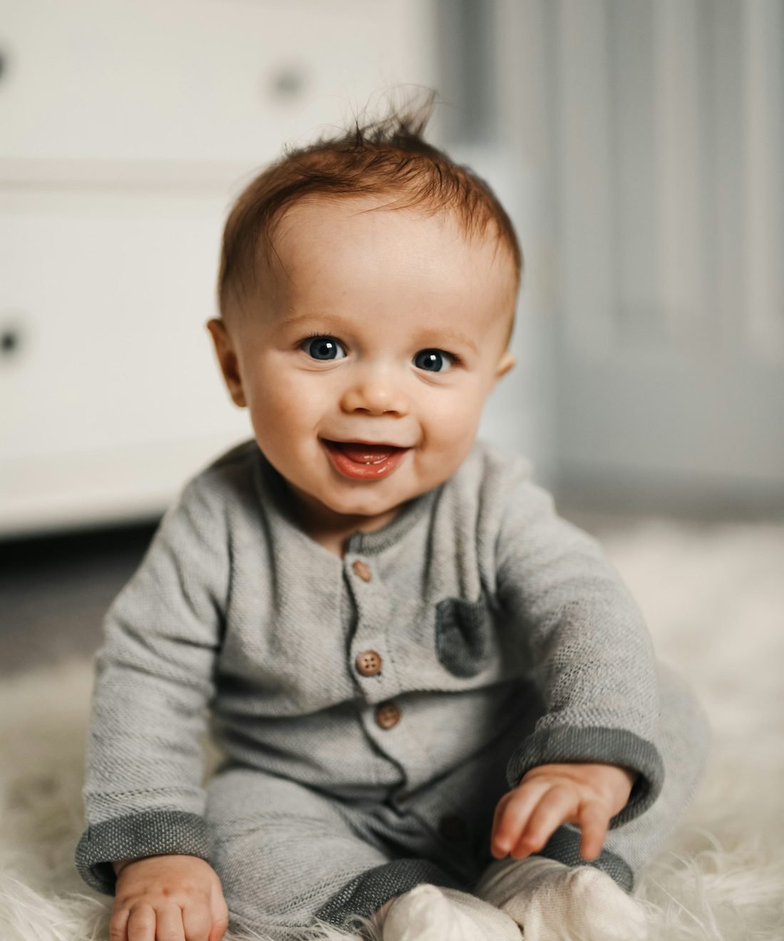 Smiling baby in a soft organic cotton romper