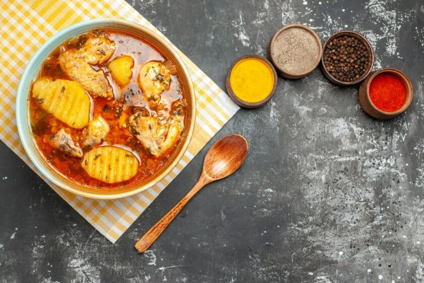 Budget friendly meal with chicken and spices on dark background