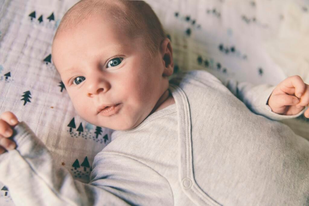 Close-up of newborn baby wearing romper