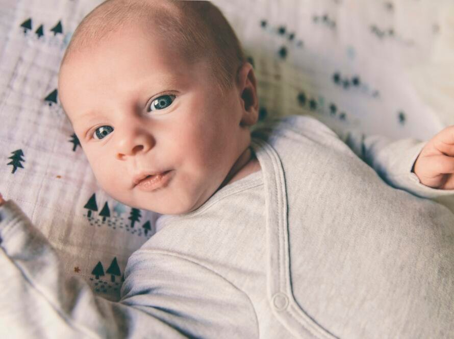 Close-up of newborn baby wearing romper