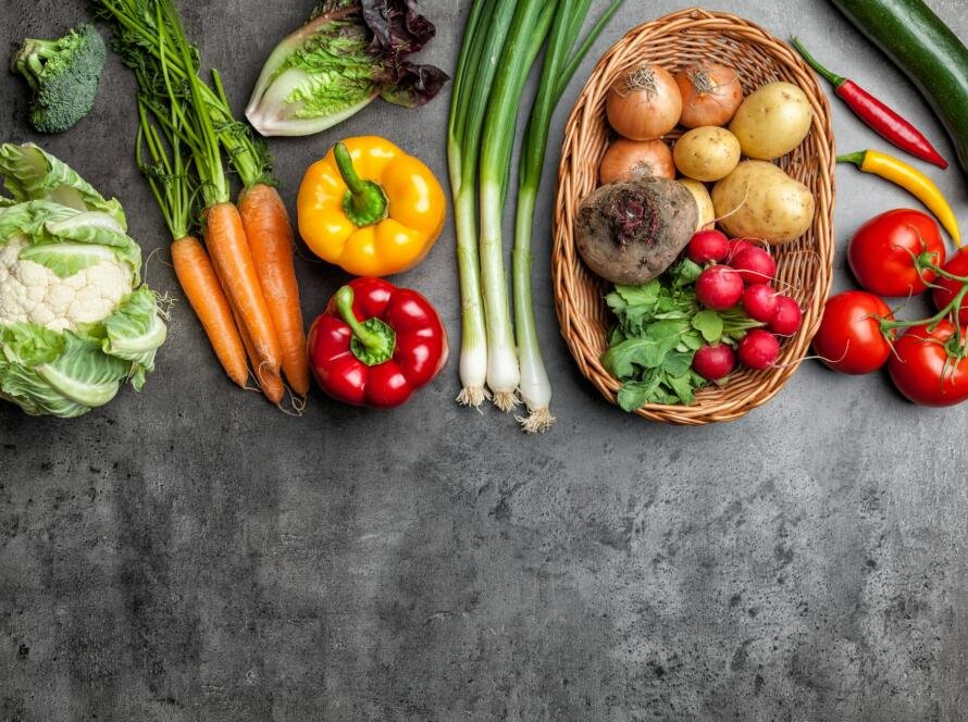 Fresh organic vegetables on rustic background