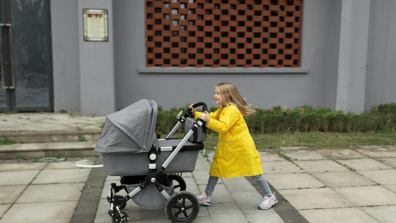 little girl walking with newborn baby sibling Colors of the year 2021 ultimate gray and illuminating