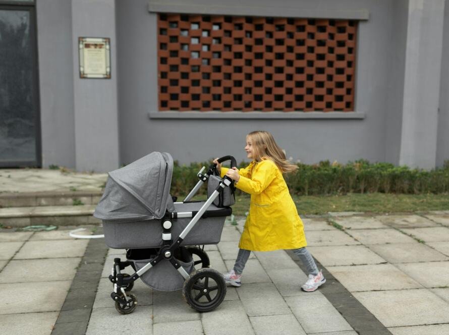 little girl walking with newborn baby sibling Colors of the year 2021 ultimate gray and illuminating