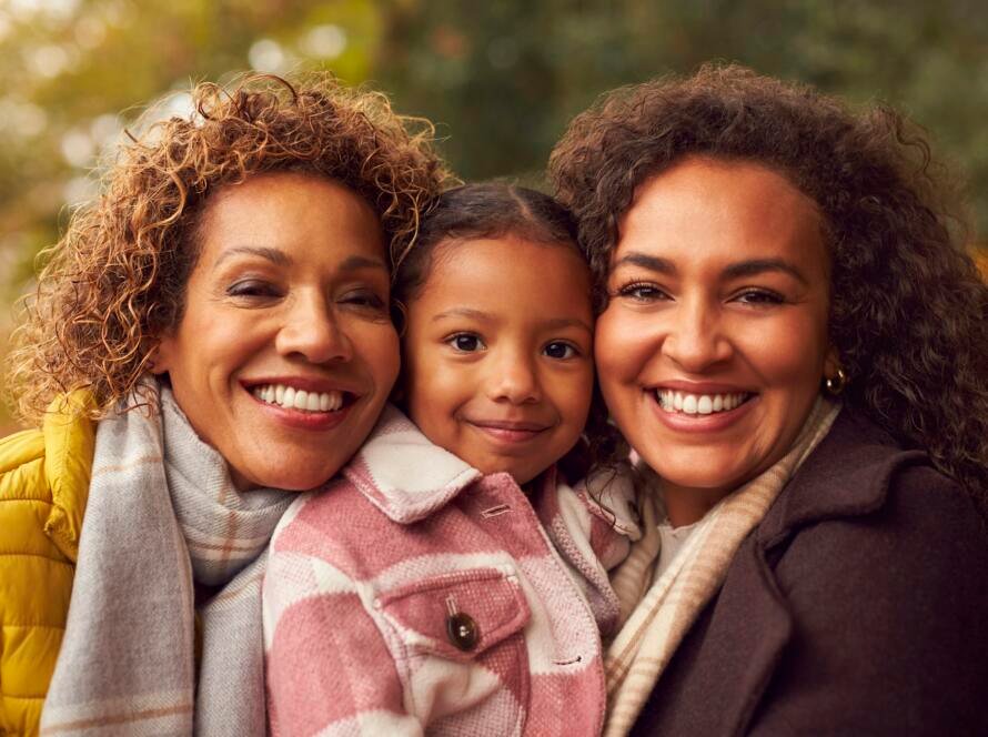 Portrait Of Multi-Generation Female Family On Walk Through Autumn Countryside Together