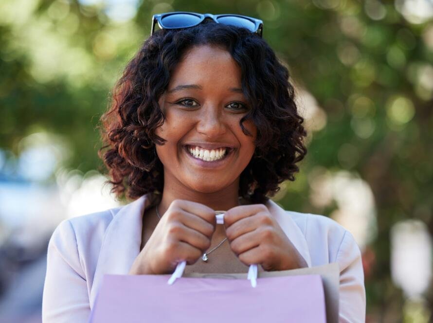 Shopping, happy and portrait of a woman in the city for fashion discount, luxury sale and boutique