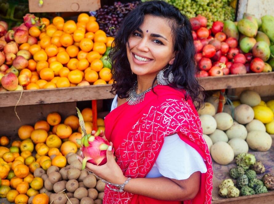 travel girl seller in street market and a buyer in a fruit shop in india