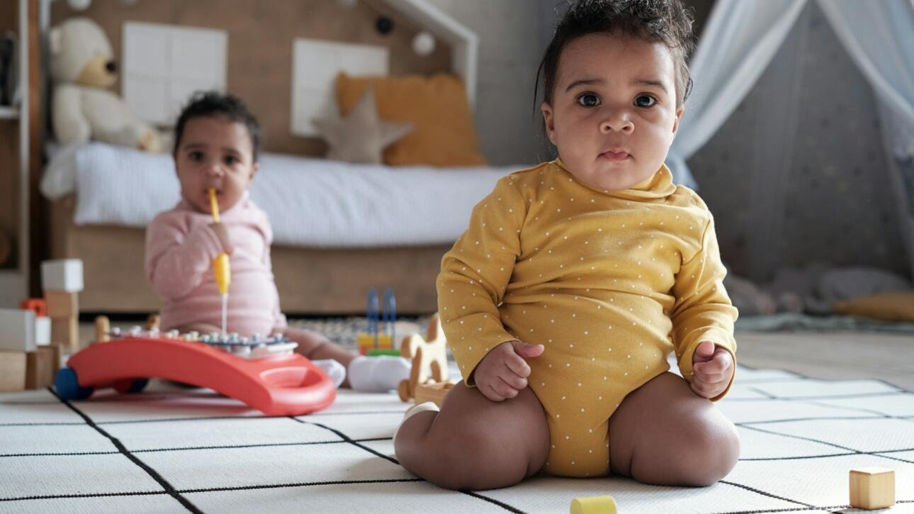 Twin Babies Sitting On Floor