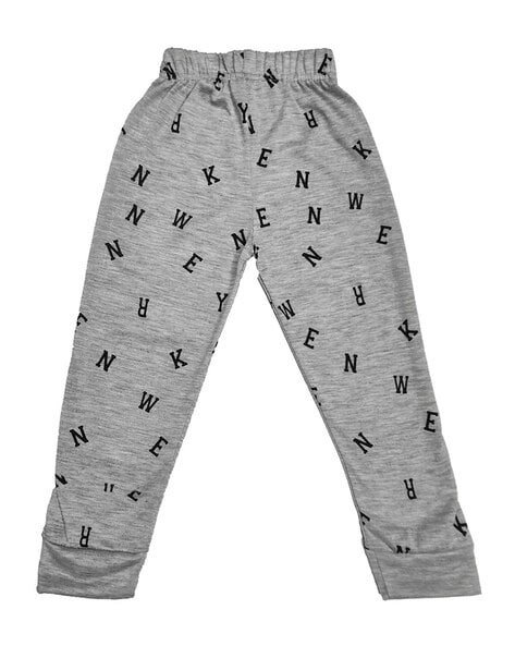 Grey trousers with an elastic waistband featuring random black letters printed all over.