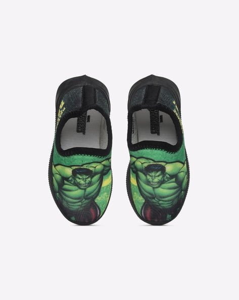 Kids' slip-on shoes with green superhero print on the upper.