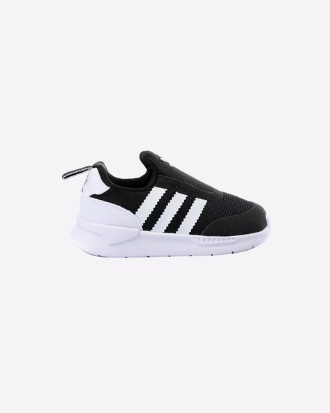 Black and white trainer with three stripes and a white sole.