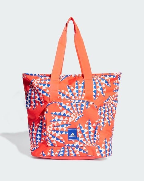 Colourful tote bag with red, white, and blue triangle pattern and Adidas logo.