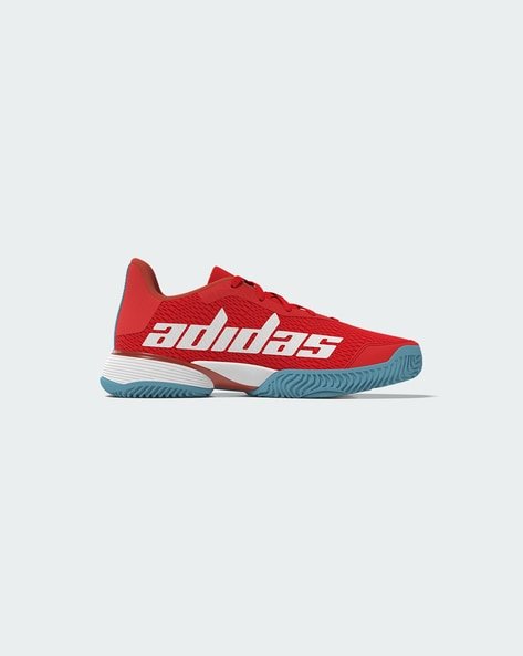 Red Adidas tennis shoe with large white logo and blue sole.