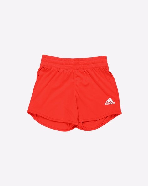 Red athletic shorts with an elastic waistband and the Adidas logo in white.