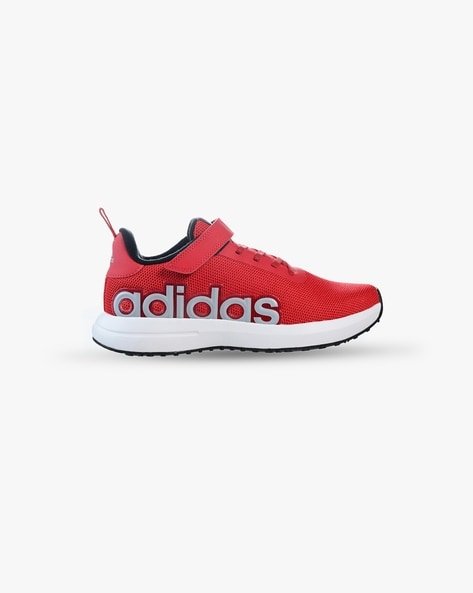 Red Adidas trainer with a Velcro strap and large logo on the side.